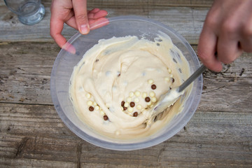 Mixing raw dough in bowl. Baking cake, muffin or homemade pastry.