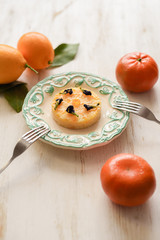 Tasty lemon pie with dry butterfly pea flowers served with fresh lemons and tangerines on white background