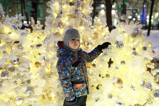 Child on background of the Christmas tree