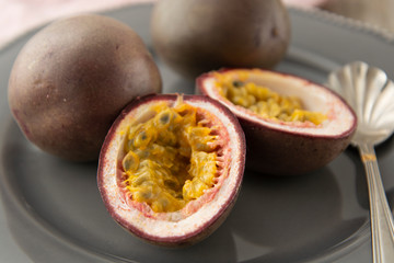 Passion fruits on wooden background. Healthy eating.