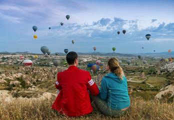 Couple looking at hot air balloons in Cappadocia