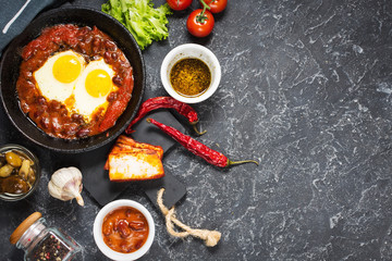Shakshuka, Fried Eggs in Tomato Sauce in iron frying pan. Typical Israel food.