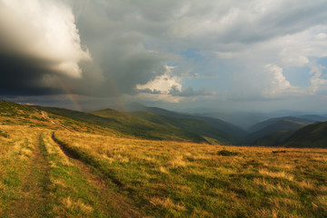 Summer landscapes of the Carpathian Mountains, with high mountain lakes and after thunderbolt rainbows.