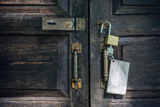 Old rusty and key locks on wooden door