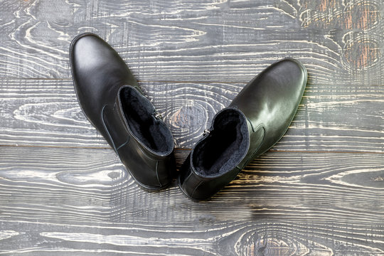 Shoe concept. Men's winter leather boots in black. have toning. close-up