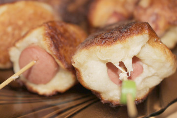 Sausages fried in batter. Sausages in the dough. Hot Dog. Sausages on skewers. Deep fried. Food. Breakfast.