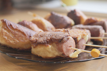 Sausages fried in batter. Sausages in the dough. Hot Dog. Sausages on skewers. Deep fried. Food. Breakfast.