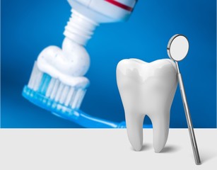 Toothpaste on a toothbrush close-up on background