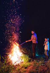 family burning brushwood on fire, seasonal cleaning of the countryside area, village lifestyle