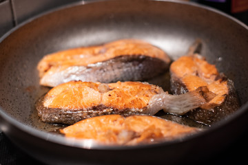 Salmon fry in pan. Cooking salmon steaks.
