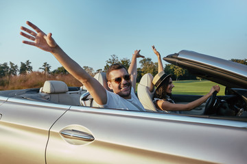 couple driving cabriolet