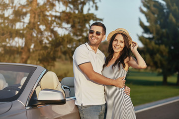 couple hugging while standing at the car