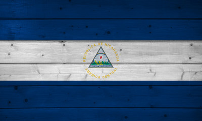 Flag of Nicaraqua on wooden background, surface. Wooden wall, planks. National flag