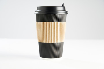 Paper disposable coffee black cup for take away or to go, isolated on white, space for design layout.