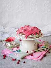 Chocolate crepe cake with with curd cream and cranberry topping on a stand. Pancake week. Sunday breakfast. Vintage. Copy space, selective focus.