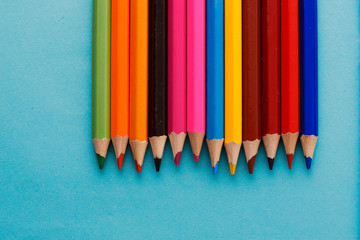 Coloured pencils isolated on the blue background