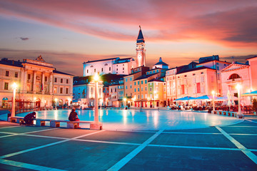 Beautiful city scenery in the central square with the old clock tower in Porec, the tourist center...