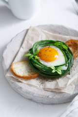Green bean nest with fried egg on toasted bread