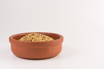 bowl of raw bulgur and quinoa isolated on white background