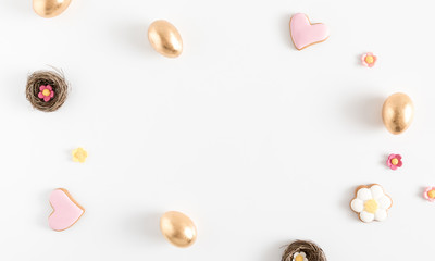 Easter golden eggs, easter decorations on white background. Flat lay, top view, copy space
