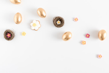 Easter golden eggs, easter decorations on white background. Flat lay, top view, copy space