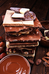 Chocolate bars on table with chocolate tower.