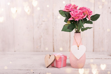 Flowers composition for Valentine's, Mother's or Women's Day. Pink flowers on old white wooden background.
