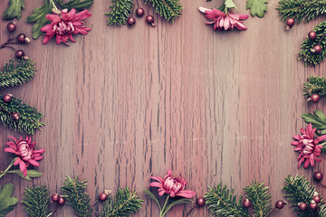 Burgundy chrysanthemum flowers on  textured background with winter decorations, copy-space