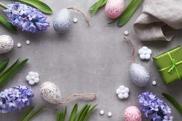 Easter flat lay with blue hyacinth flowers, easter eggs and large heart on light background