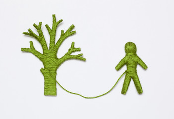 green yarn tree and human figure, isolated on white background. Ecology concept