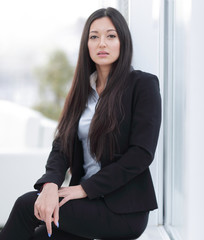 young employee sitting near a window in the office