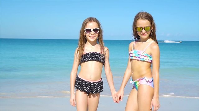 Kids having fun at tropical beach during summer vacation playing together.