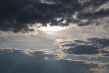 Fototapeta na wymiar Sun lights coming through clouds. Skyscape at sunset.