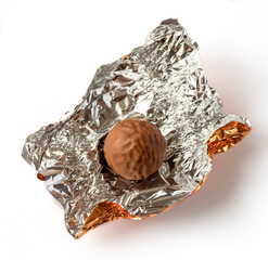 Chocolate praline wrapped in foil. Isolated on white background