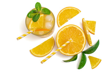 glass of freshly squeezed orange juice with sliced fresh oranges. Isolated on white. Top view