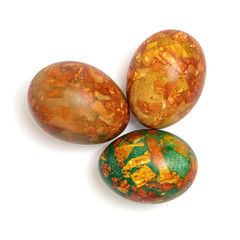 Three colorful handmade easter eggs isolated on a white. Top view