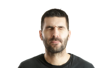 Obraz premium Studio shot of a young bearded man making a facial expression