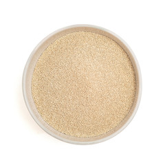 dry yeast in bowl isolated on white background. Top view