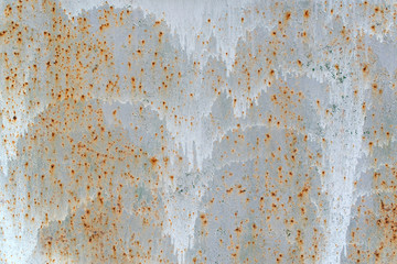Gray rusty wall with stains of white paint. Sheet of iron with rust. Grunge rusted metal texture,...
