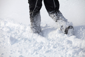Man walking in deep high snow