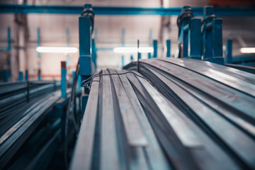 long and short steel pipes lay on shop rack