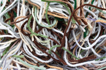 A pile of pieces of colored acrylic yarn from a crochet project.