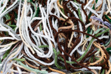 A pile of pieces of colored acrylic yarn from a crochet project.
