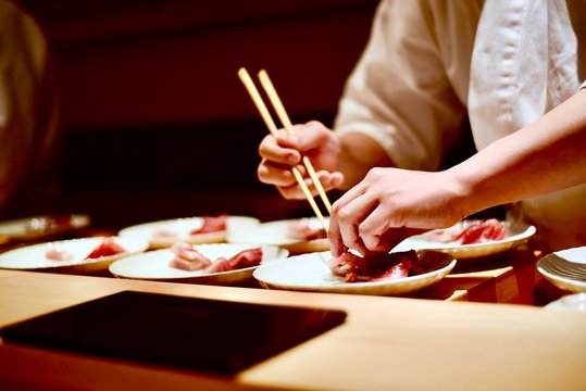 Master sushi chef preparing omakase tasting course in Tokyo, Japan