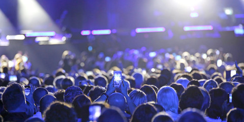people at live concert with mobile phone take pictures