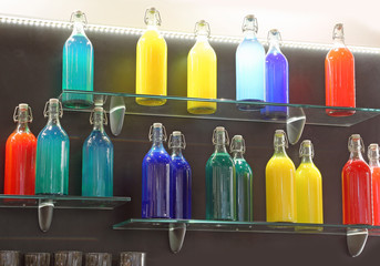 glass bottles on top of the shelf