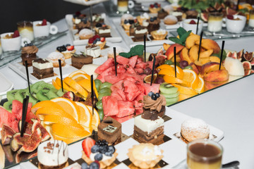 fruits, sweets and drinks on the table