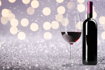 Red wine glass and buttle on wooden desk background