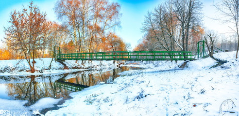 Winter frosty trees and old snowy bridge in the winter park