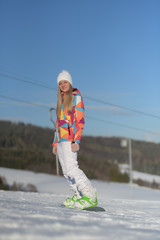 snowboarder on slopes in the sunny morning